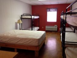 Dorm configured with 8 bunk beds and counselor bed