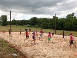 Students playing sand volleyball